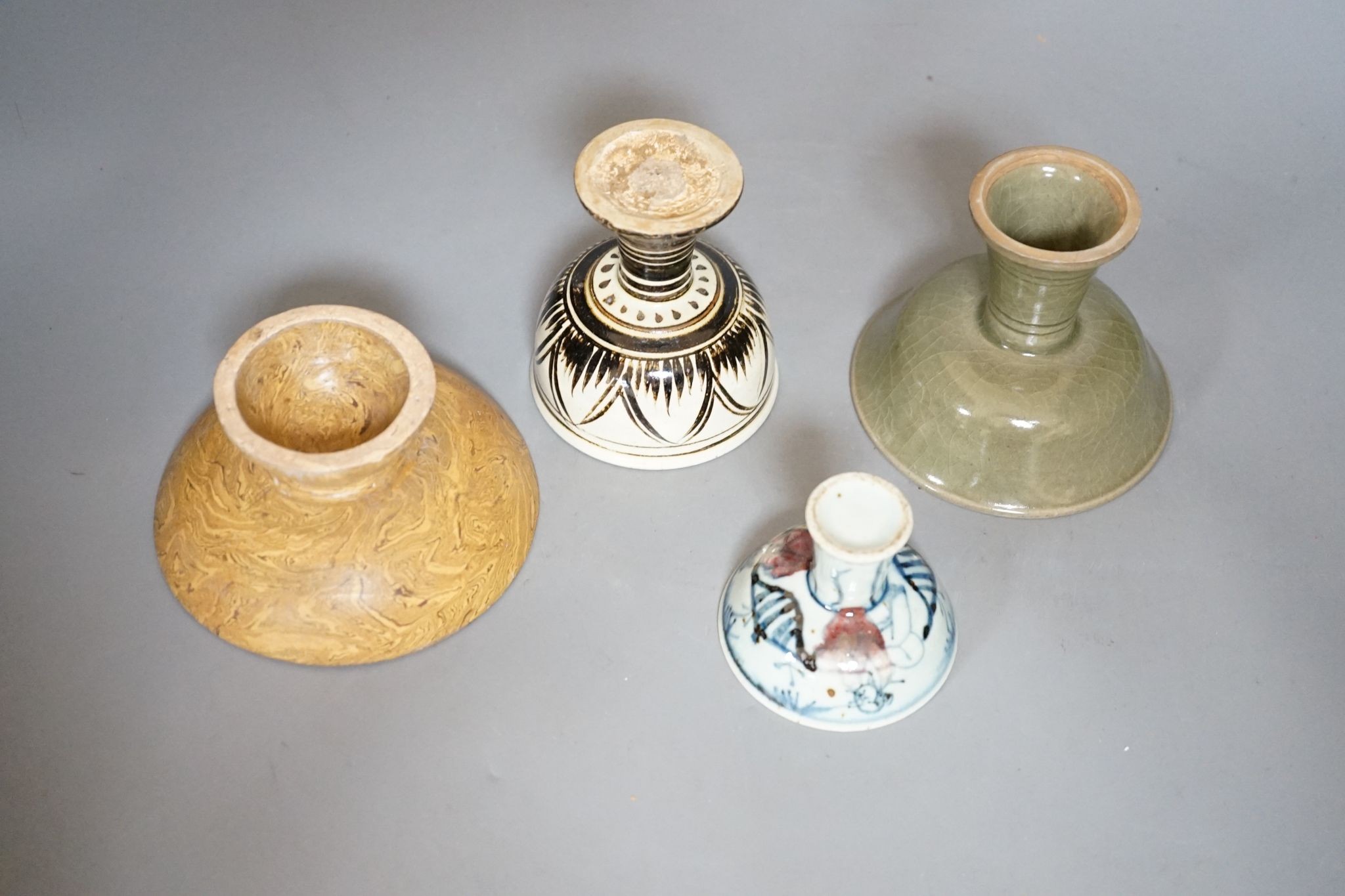 Four various Chinese pottery or porcelain stem cups, tallest 10cm